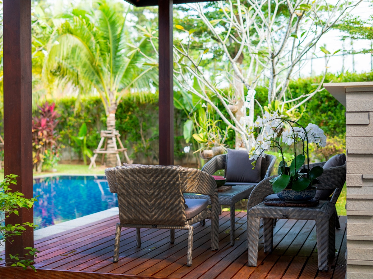 Une terrasse de jardin à l'ombre d'une pergolas au bord d'une piscine