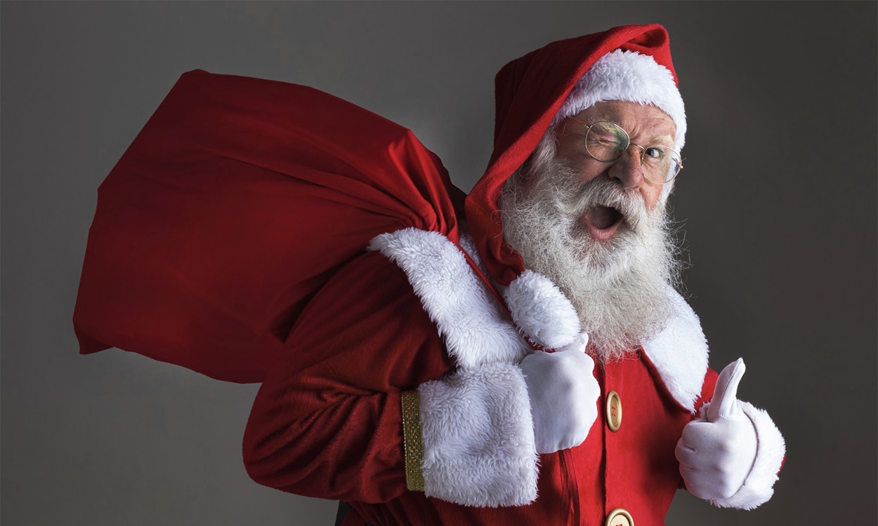 Père Noel tenant une hotte faisant un clin d'oeil avec le pouce en l'air