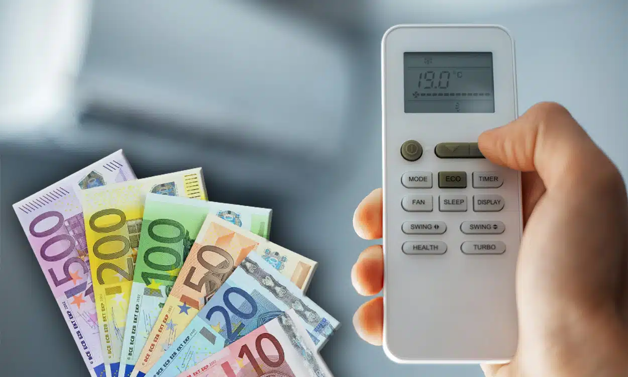 Gros plan sue la télécommande d'une climatisation réversible avec des billets de banque en euro